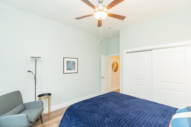 bedroom with a closet, ceiling fan, and light hardwood / wood-style flooring