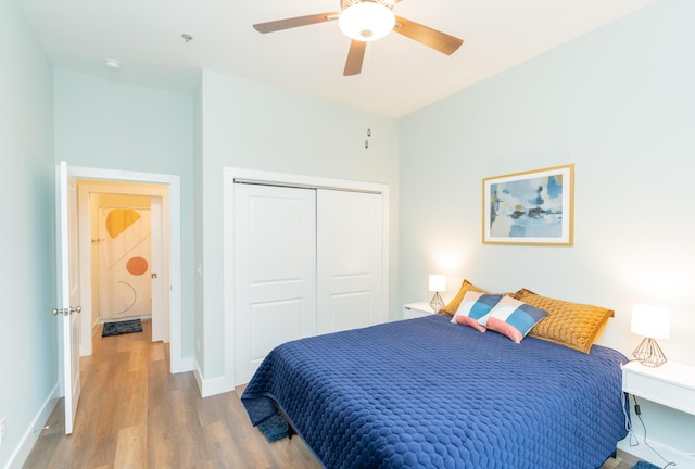 bedroom featuring hardwood / wood-style floors, a closet, and ceiling fan