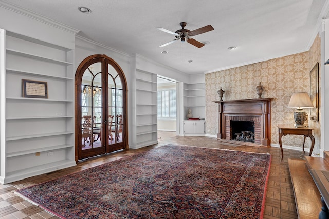 living room with french doors, dark parquet floors, a brick fireplace, ornamental molding, and a textured ceiling