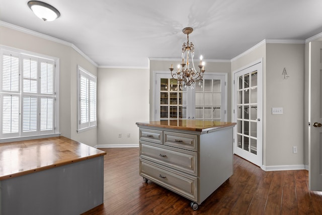 interior space featuring a chandelier, dark wood-type flooring, and crown molding