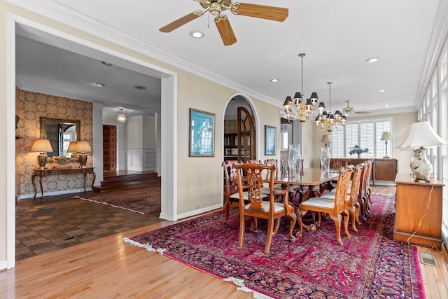 dining room with ceiling fan with notable chandelier and ornamental molding