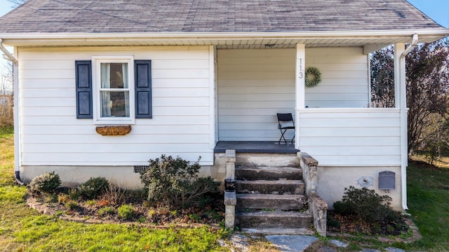 view of exterior entry with covered porch