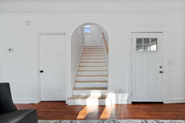 stairway featuring a wealth of natural light, hardwood / wood-style floors, and ornamental molding