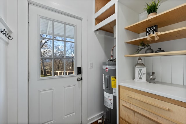 doorway to outside featuring electric water heater