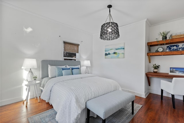 bedroom with dark hardwood / wood-style flooring and ornamental molding