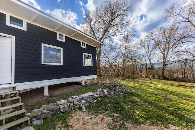 view of property exterior with a lawn