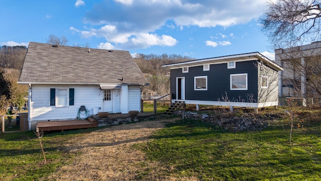 rear view of property with a yard