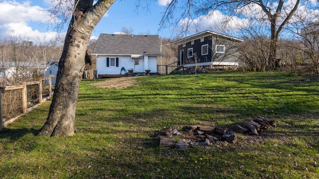 rear view of house featuring a yard