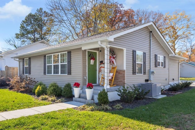 ranch-style house featuring cooling unit and a front yard