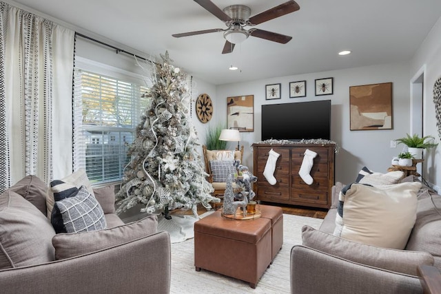 living room with light wood-type flooring and ceiling fan