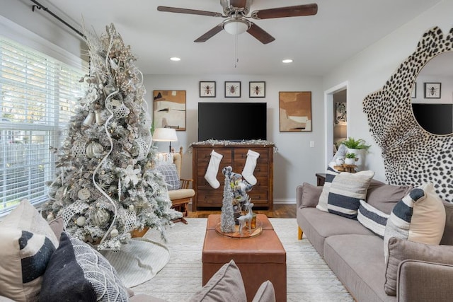 living room featuring light hardwood / wood-style floors and ceiling fan