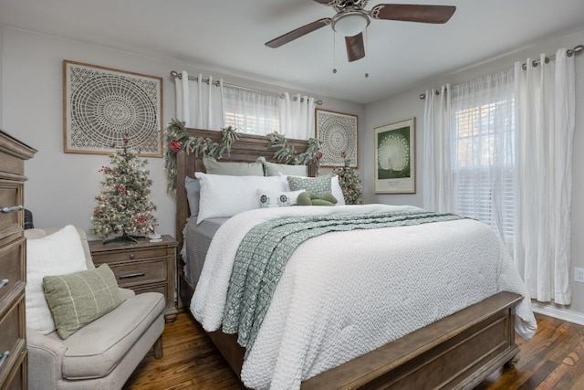 bedroom with ceiling fan and dark wood-type flooring