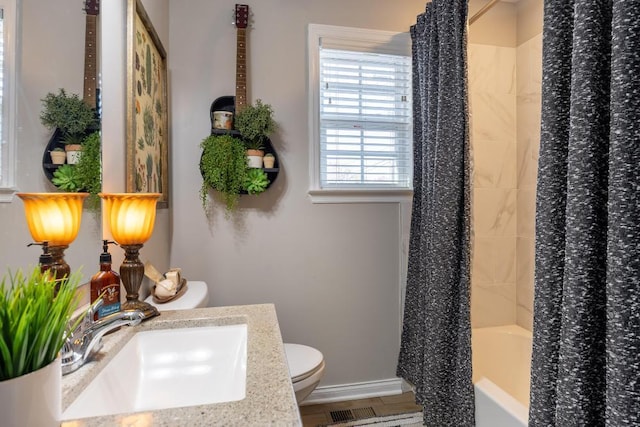 full bathroom with wood-type flooring, toilet, shower / bath combo with shower curtain, and sink