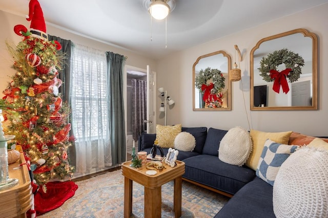 living room featuring plenty of natural light and ceiling fan