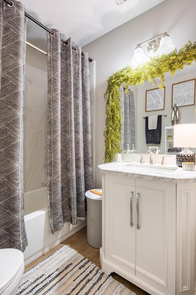 full bathroom featuring shower / tub combo, vanity, and toilet