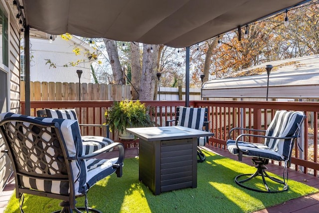 wooden terrace featuring a lawn