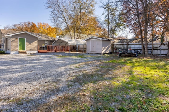 view of yard featuring a carport and a storage unit