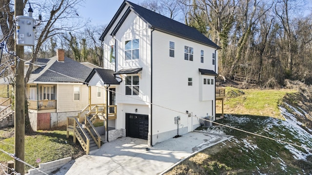 view of home's exterior with central AC unit and a garage