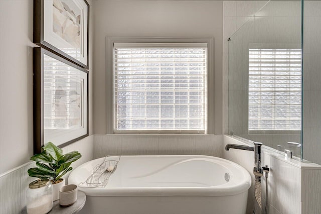 bathroom with a tub to relax in