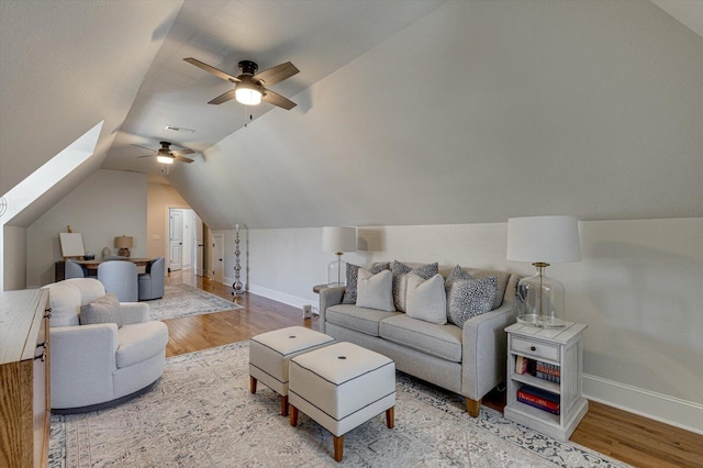 living room featuring hardwood / wood-style flooring, ceiling fan, and lofted ceiling