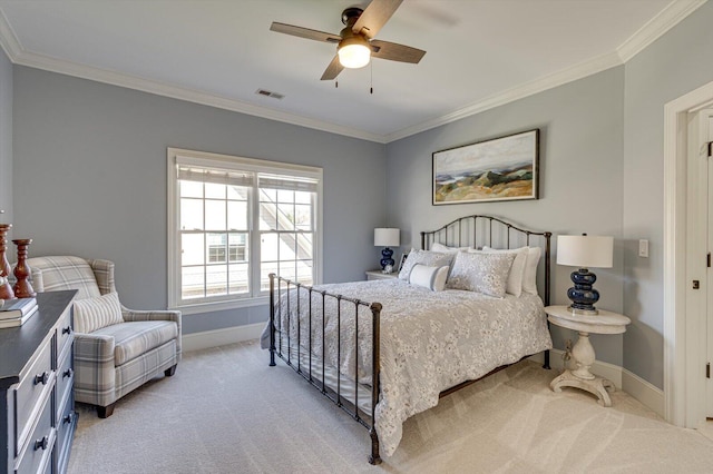 carpeted bedroom featuring ceiling fan and crown molding