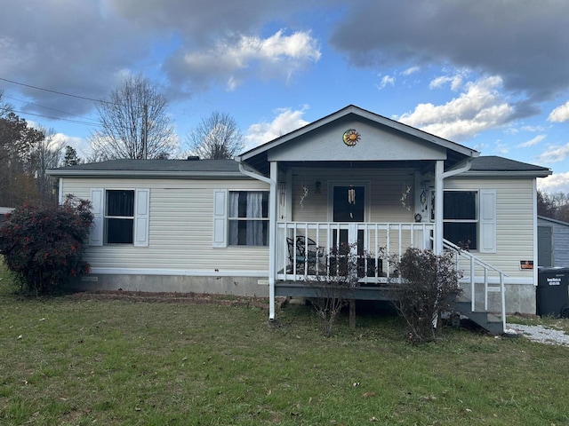 view of front of house with covered porch and a front yard