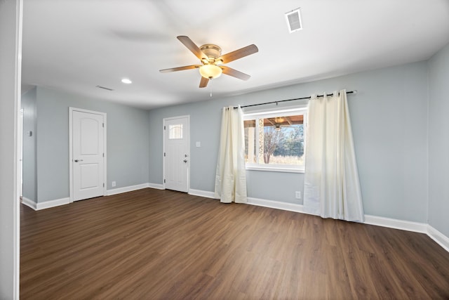 empty room featuring ceiling fan and dark wood-type flooring