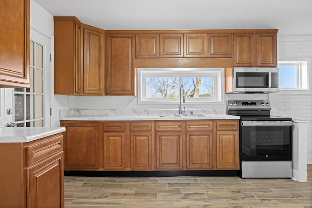 kitchen featuring appliances with stainless steel finishes, plenty of natural light, and sink