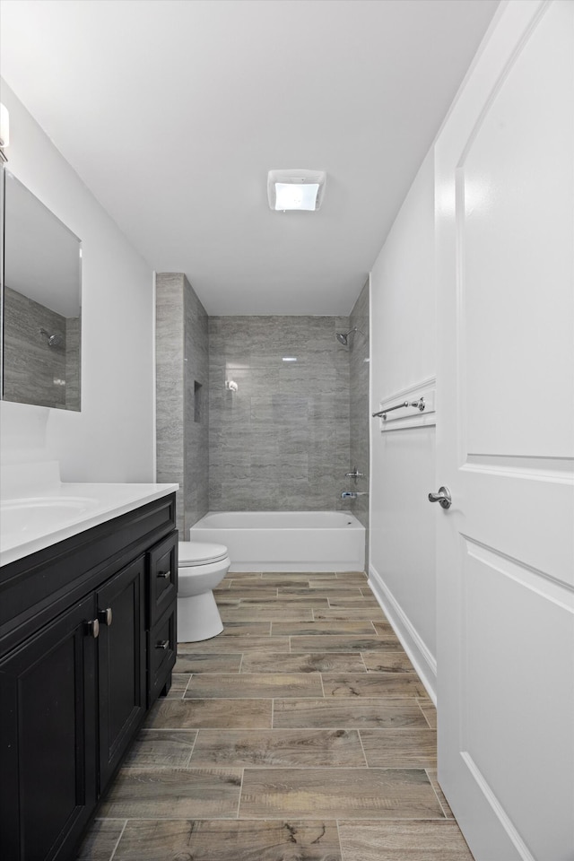 full bathroom with vanity, toilet, and tiled shower / bath