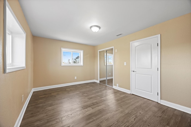 unfurnished bedroom with dark hardwood / wood-style floors