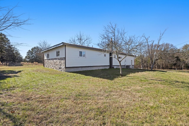 view of home's exterior with a lawn