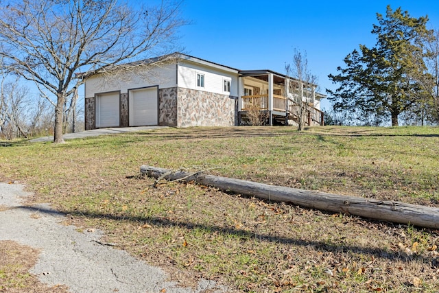 view of front facade with a front yard, a porch, and a garage