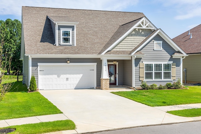 craftsman house with a front yard and a garage