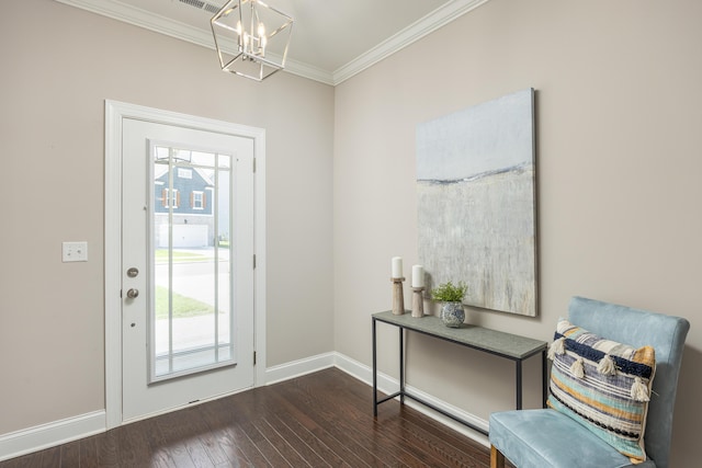 foyer featuring a notable chandelier, a healthy amount of sunlight, dark hardwood / wood-style floors, and ornamental molding