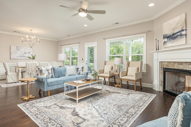 living room with ornamental molding, dark wood-type flooring, and a healthy amount of sunlight