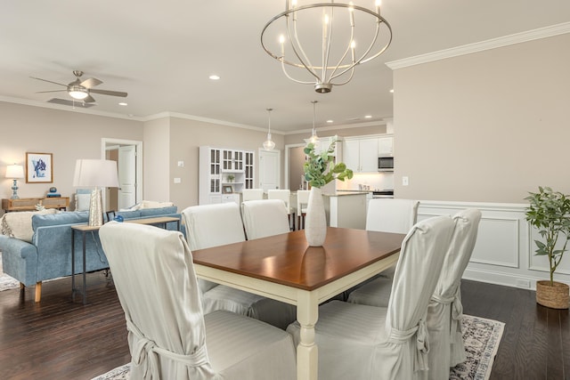 dining space featuring ornamental molding, ceiling fan with notable chandelier, and dark wood-type flooring