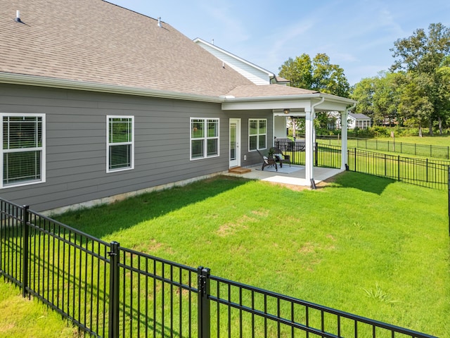 back of property featuring a yard and a patio