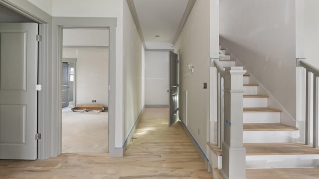 corridor with light hardwood / wood-style floors