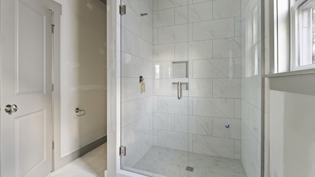 bathroom featuring a shower with door