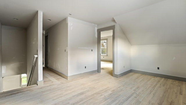 bonus room with lofted ceiling and light hardwood / wood-style floors