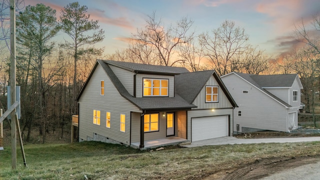 view of front of house featuring a garage and a yard