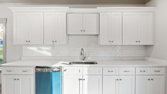 kitchen with sink, white cabinetry, light stone counters, dishwasher, and backsplash