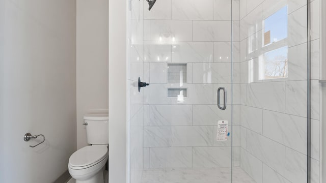 bathroom with an enclosed shower and toilet