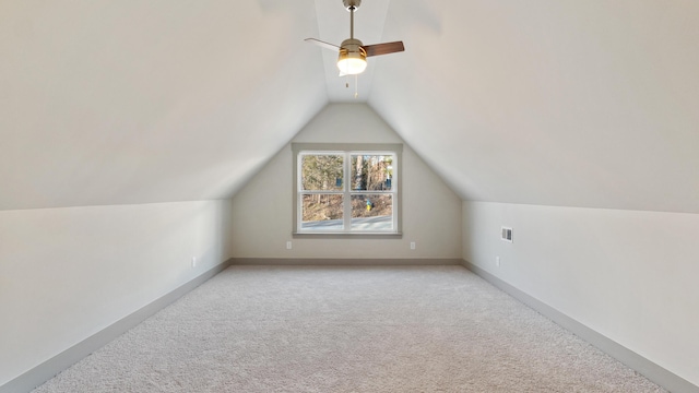 bonus room featuring lofted ceiling and light colored carpet