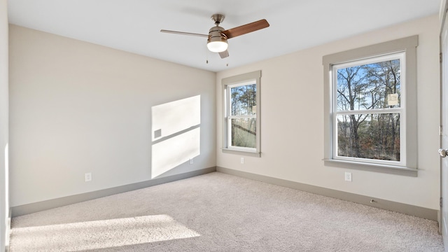 spare room with carpet floors and ceiling fan