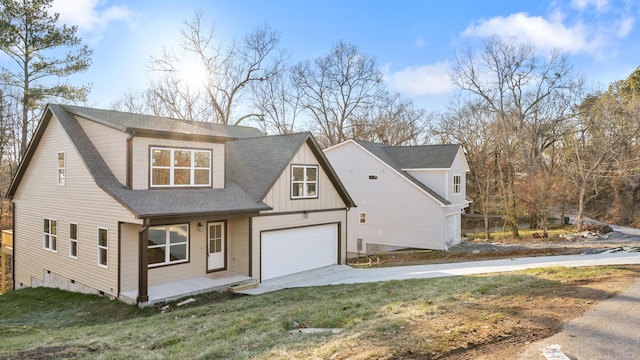 view of front of property with a garage and a front lawn