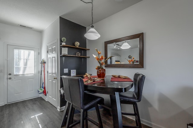 dining space featuring dark hardwood / wood-style flooring