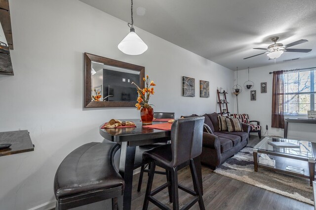 dining area featuring ceiling fan and dark wood-type flooring