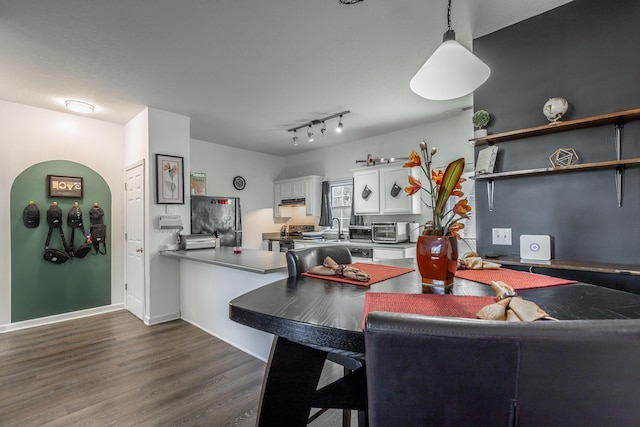 dining area featuring dark hardwood / wood-style floors and sink