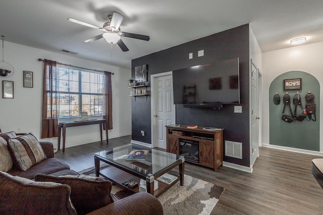 living room with ceiling fan and dark hardwood / wood-style floors